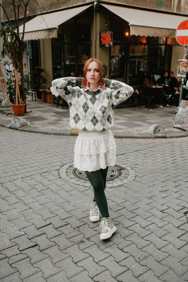 Woman wearing a sweater with a mini skirt for fall brunch