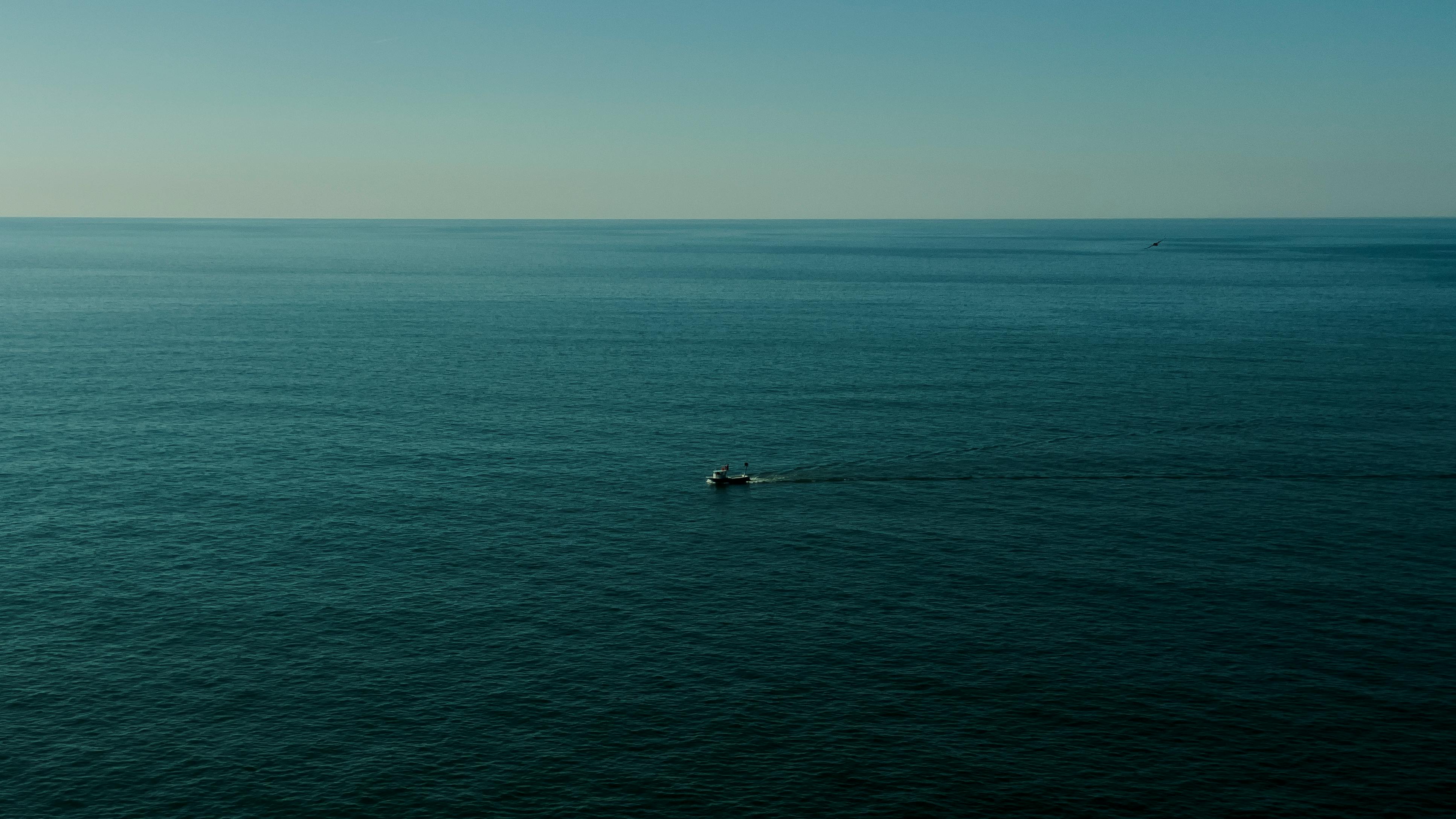 A fishing boat sails on the serene Black Sea near Arhavi, Türkiye.