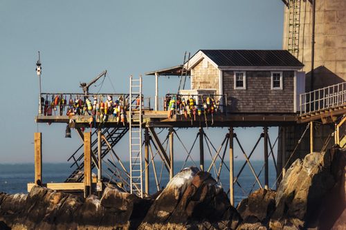 Free A classic lobster shack on a pier in Boston Harbor, showcasing traditional nautical charm. Stock Photo