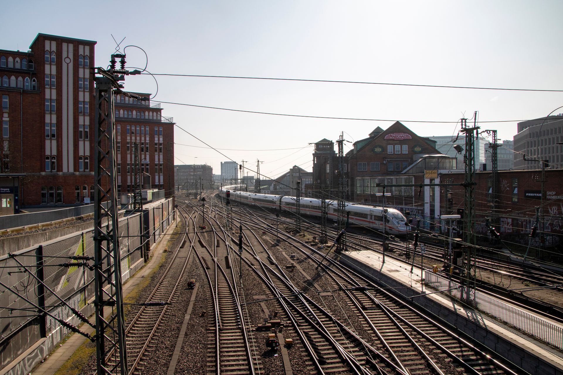 A vibrant scene of train tracks with a Deutsche Bahn train in Hamburg, Germany.