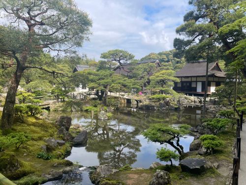 Free Beautiful Japanese garden with pond and traditional buildings. Peaceful and serene. Stock Photo
