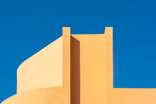 Free Minimalist architectural design with bold yellow and blue contrast captured in daylight. Stock Photo