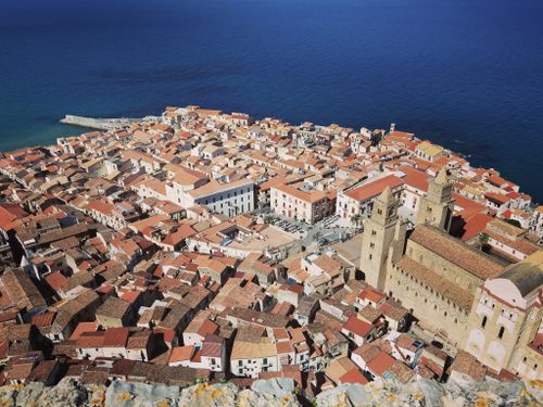 Free A stunning aerial shot showcasing the historic architecture of a coastal Italian city by the sea. Stock Photo