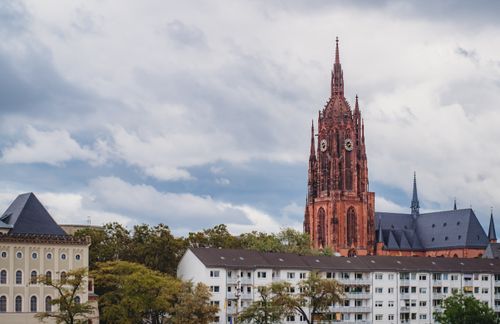 Free View of Frankfurt Cathedral, Gothic architecture, under a cloudy sky. Stock Photo