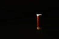 Elegant Minimalist Spool of Thread on Dark Background