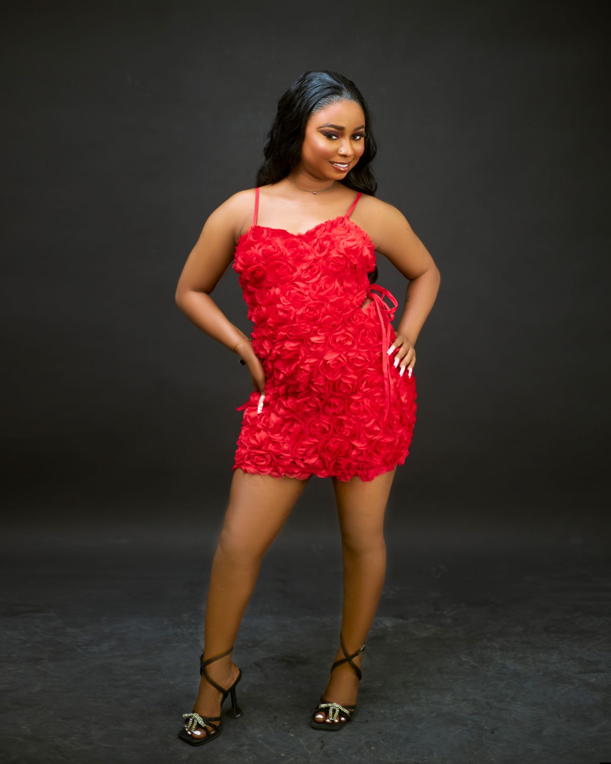 Elegant Woman in Red Floral Dress Posing · Free Stock Photo