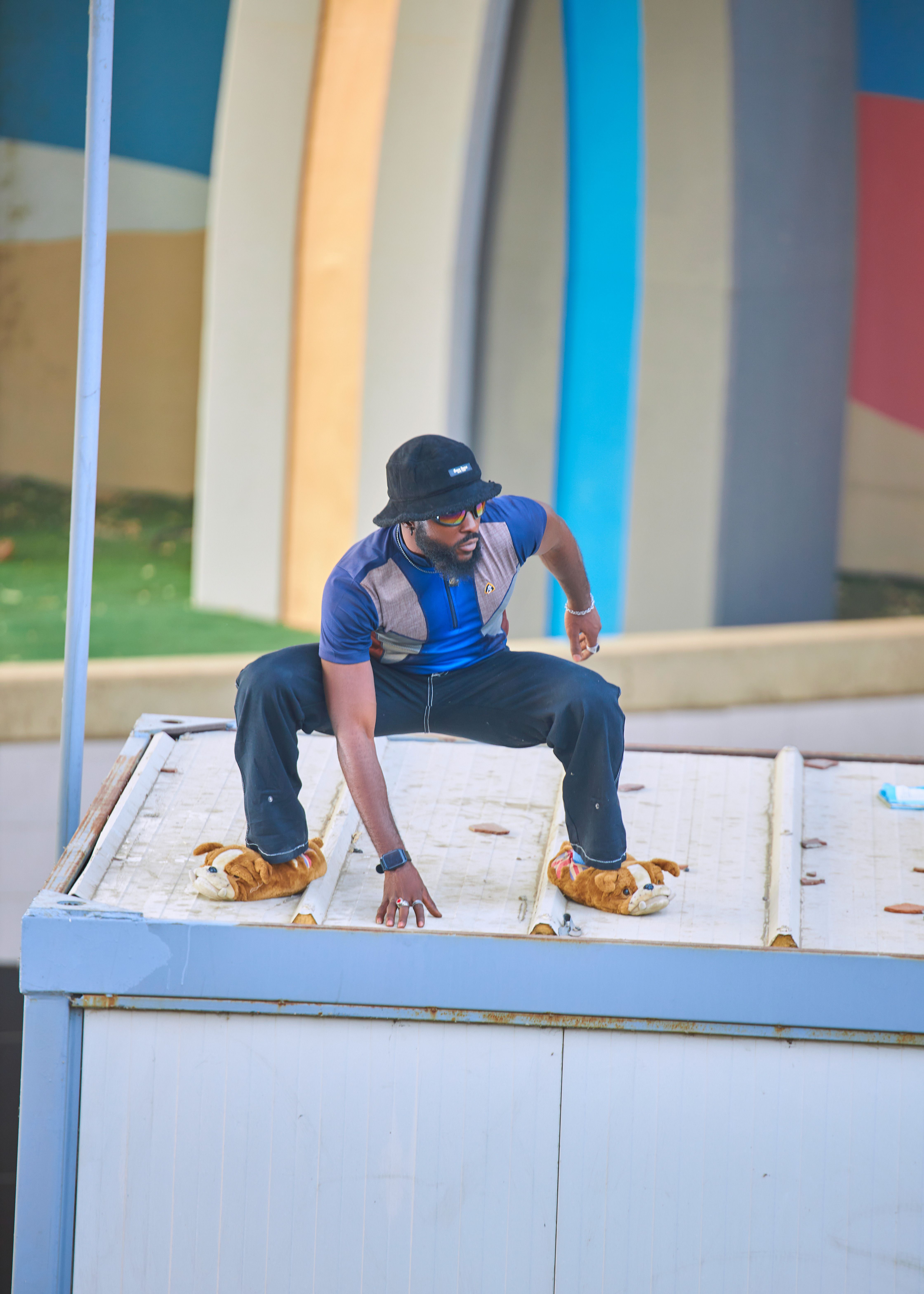 Man Posing on Rooftop with Colorful Background · Free Stock Photo