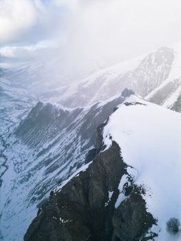 Breathtaking view of snow-covered mountain peaks and ridges in Dragash during winter.