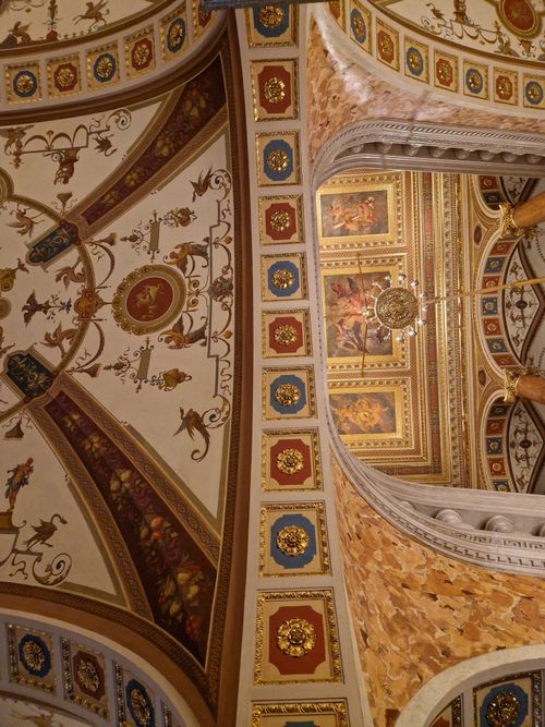 Free A close-up view of a beautifully ornate and detailed ceiling in a historical building, showcasing artistic craftsmanship. Stock Photo