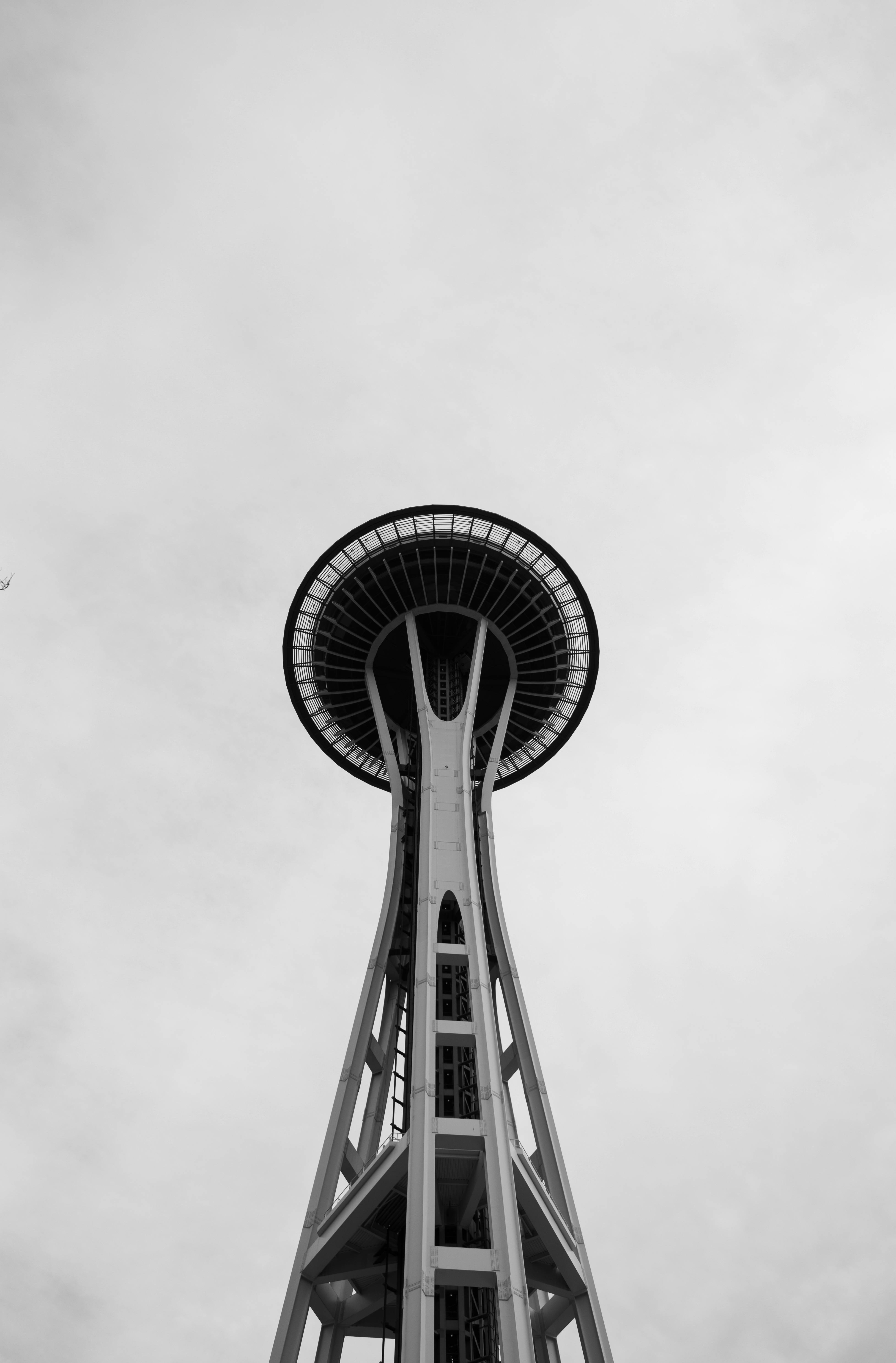 A striking black and white photo capturing the Seattle Space Needle from below.