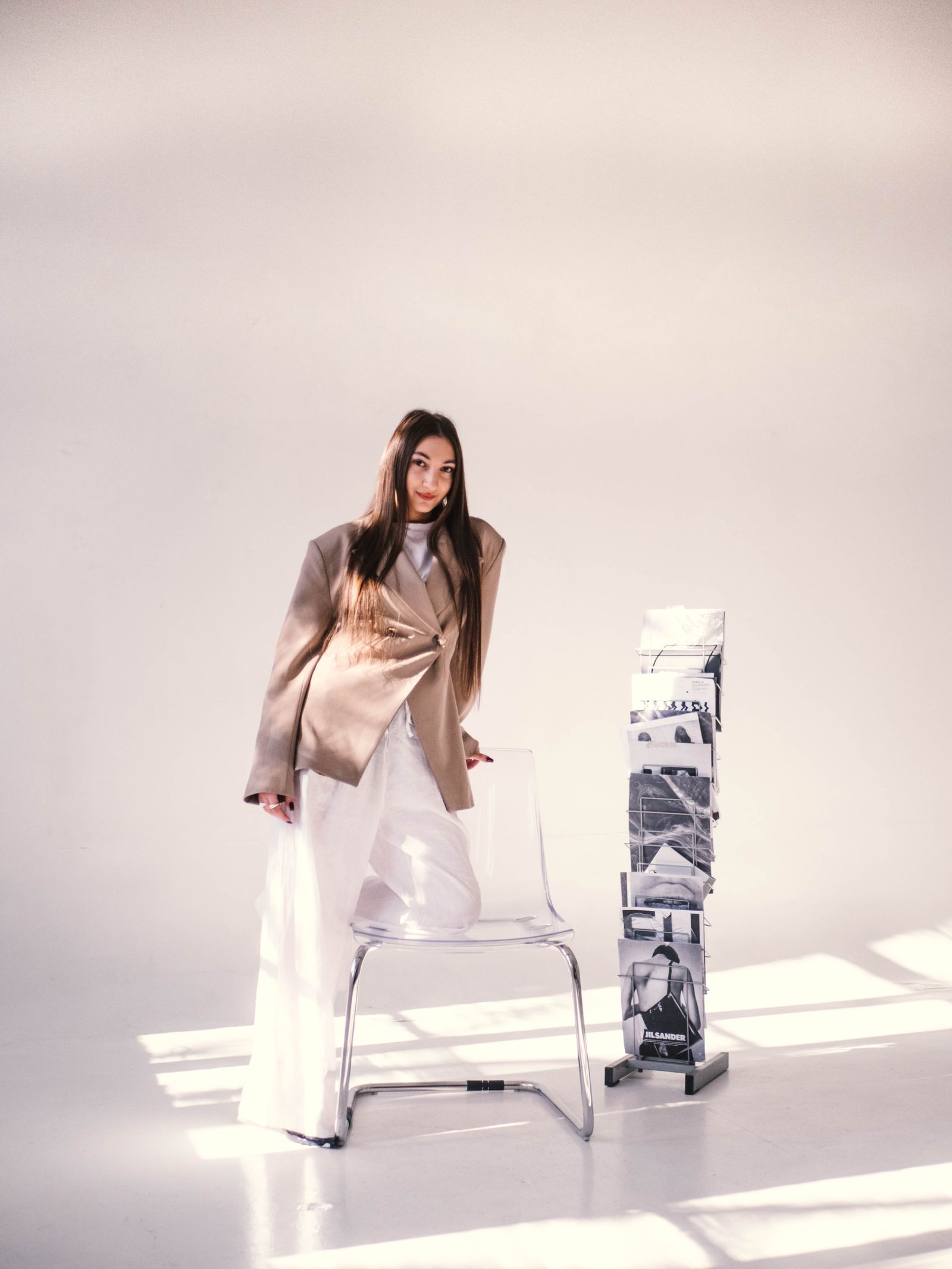 A stylish woman in a modern office setting wearing tailored trousers