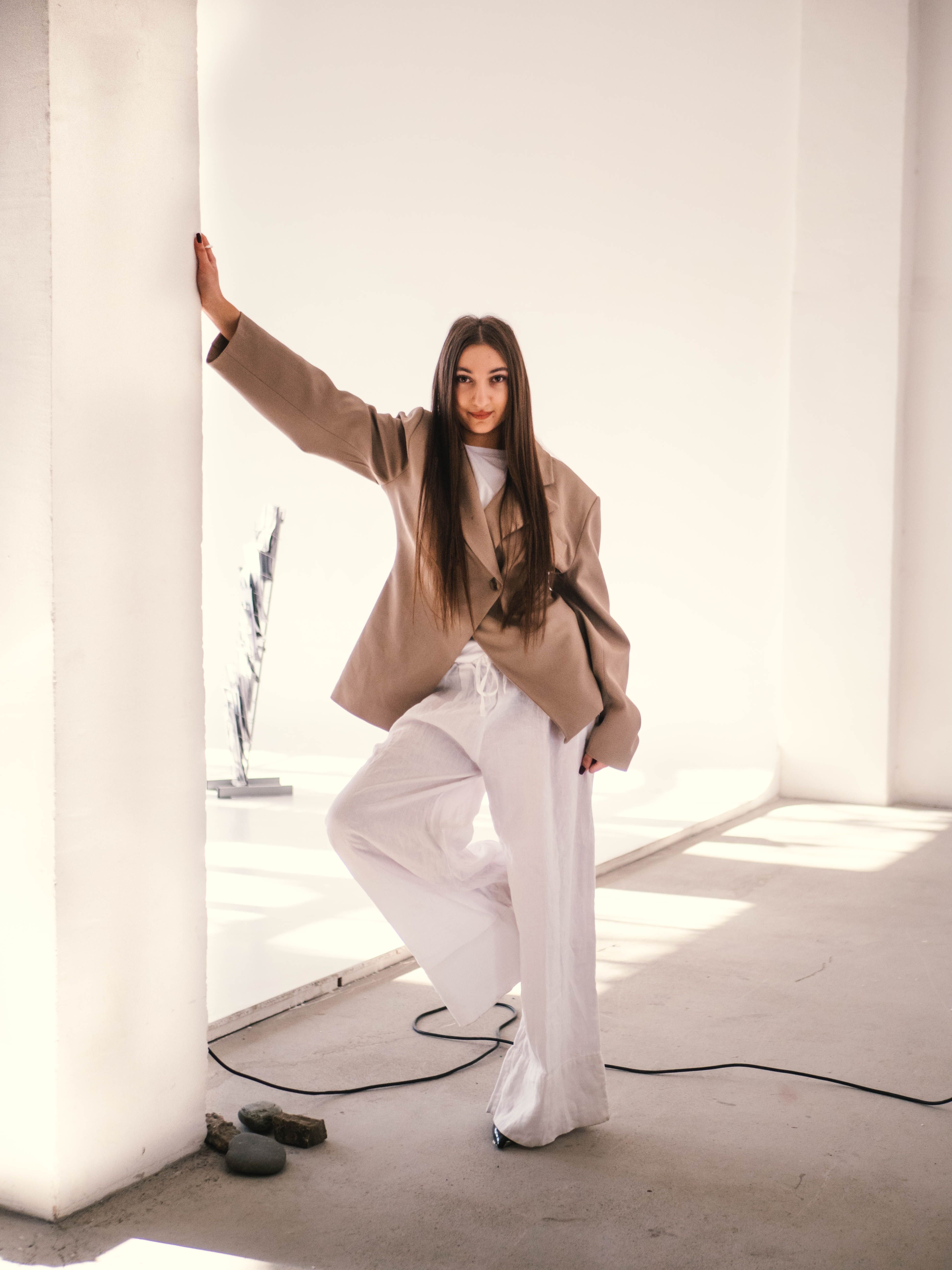 Stylish Woman Posing in Modern Indoor Setting · Free Stock Photo