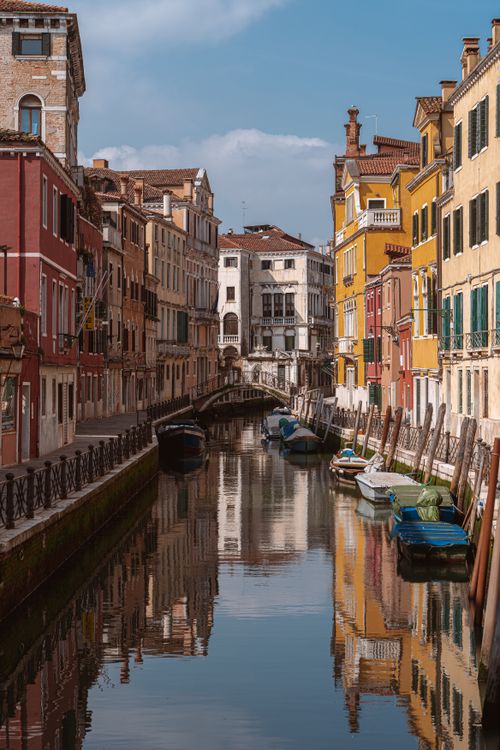 Free Explore a tranquil canal in Venice, Italy, lined with colorful historical buildings. Stock Photo