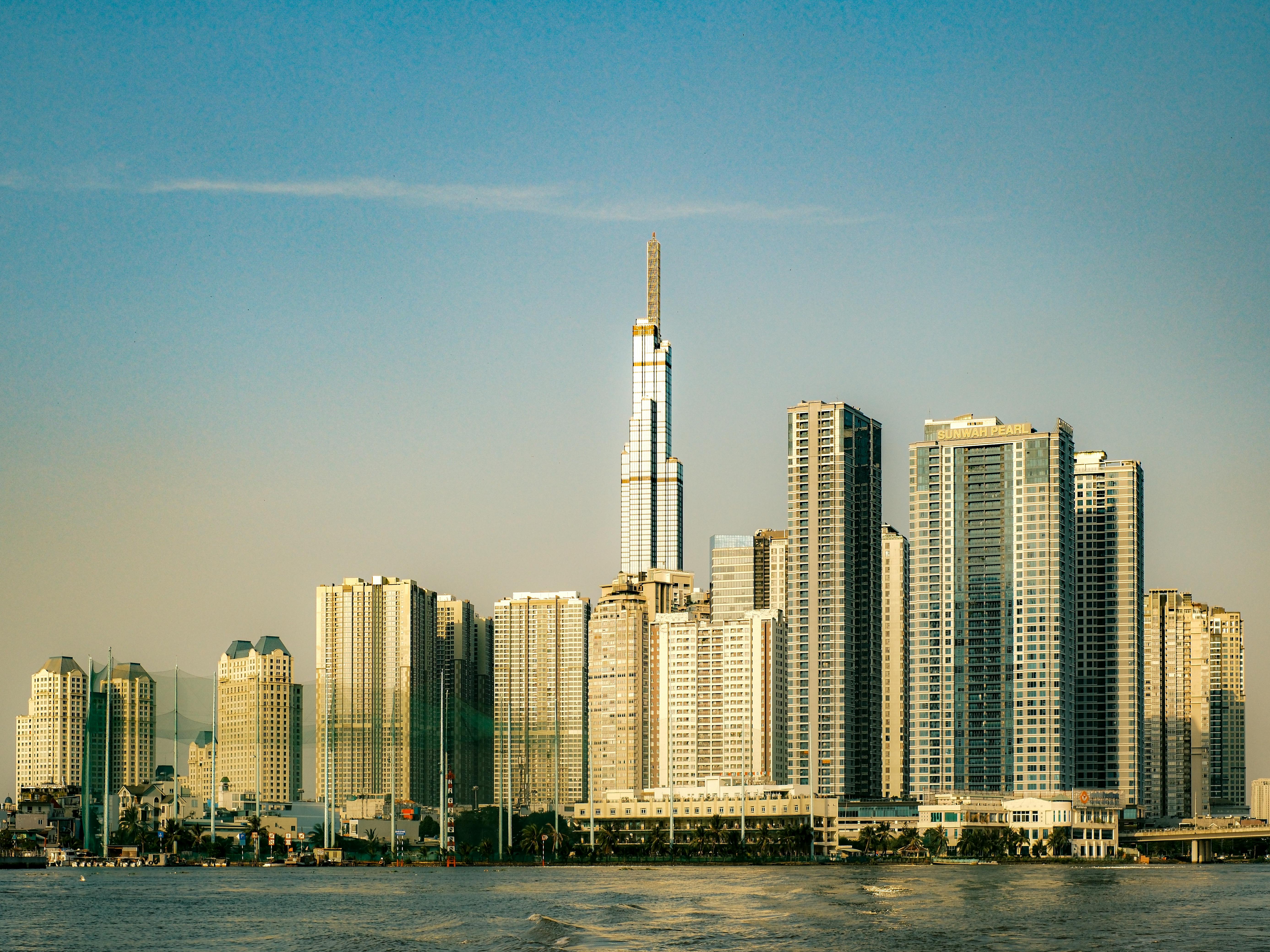 View of Ho Chi Minh City's skyline highlighting the Landmark 81 during sunset along the Saigon River.