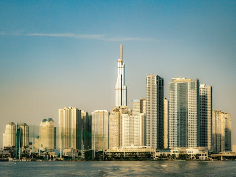 View of Ho Chi Minh City's skyline highlighting the Landmark 81 during sunset along the Saigon River.
