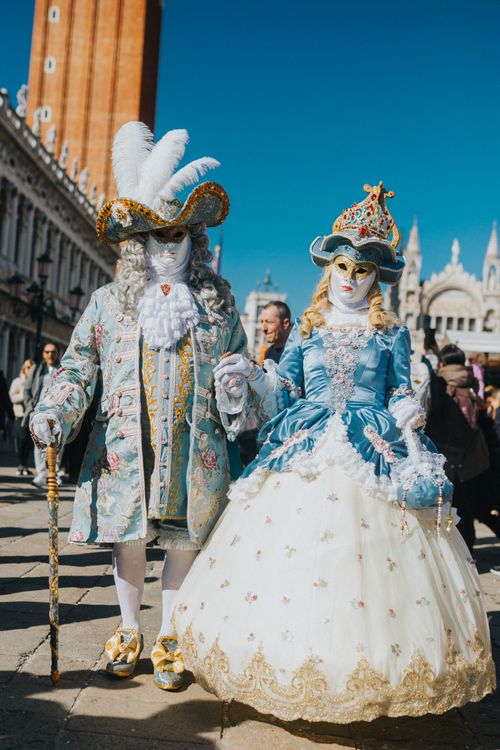 Free A pair in elaborate Venetian costumes during the Venice Carnival, showcasing intricate details and vibrant colors. Stock Photo