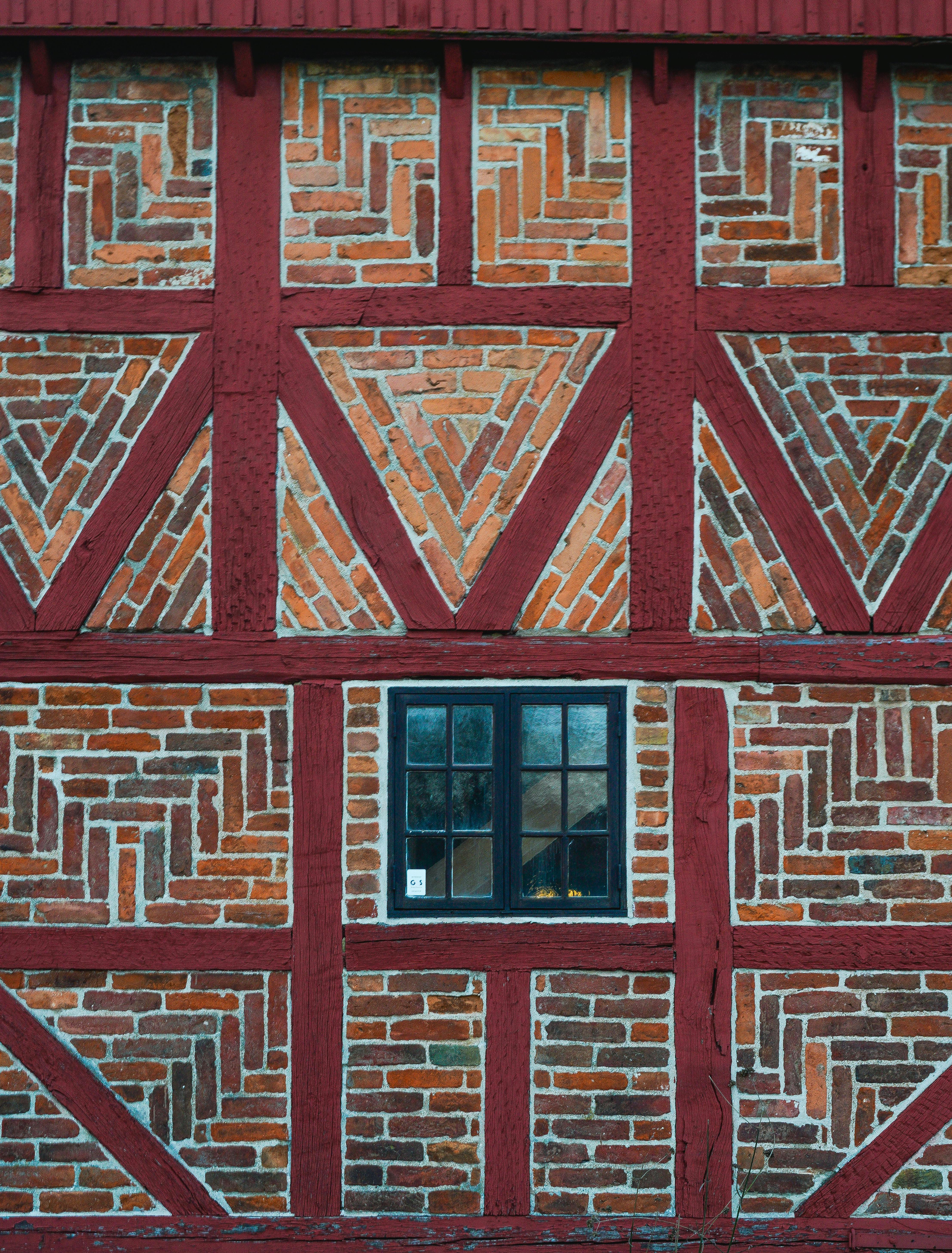 Detail of traditional Scandinavian brick and timber facade with window in Ystad, Skåne County.