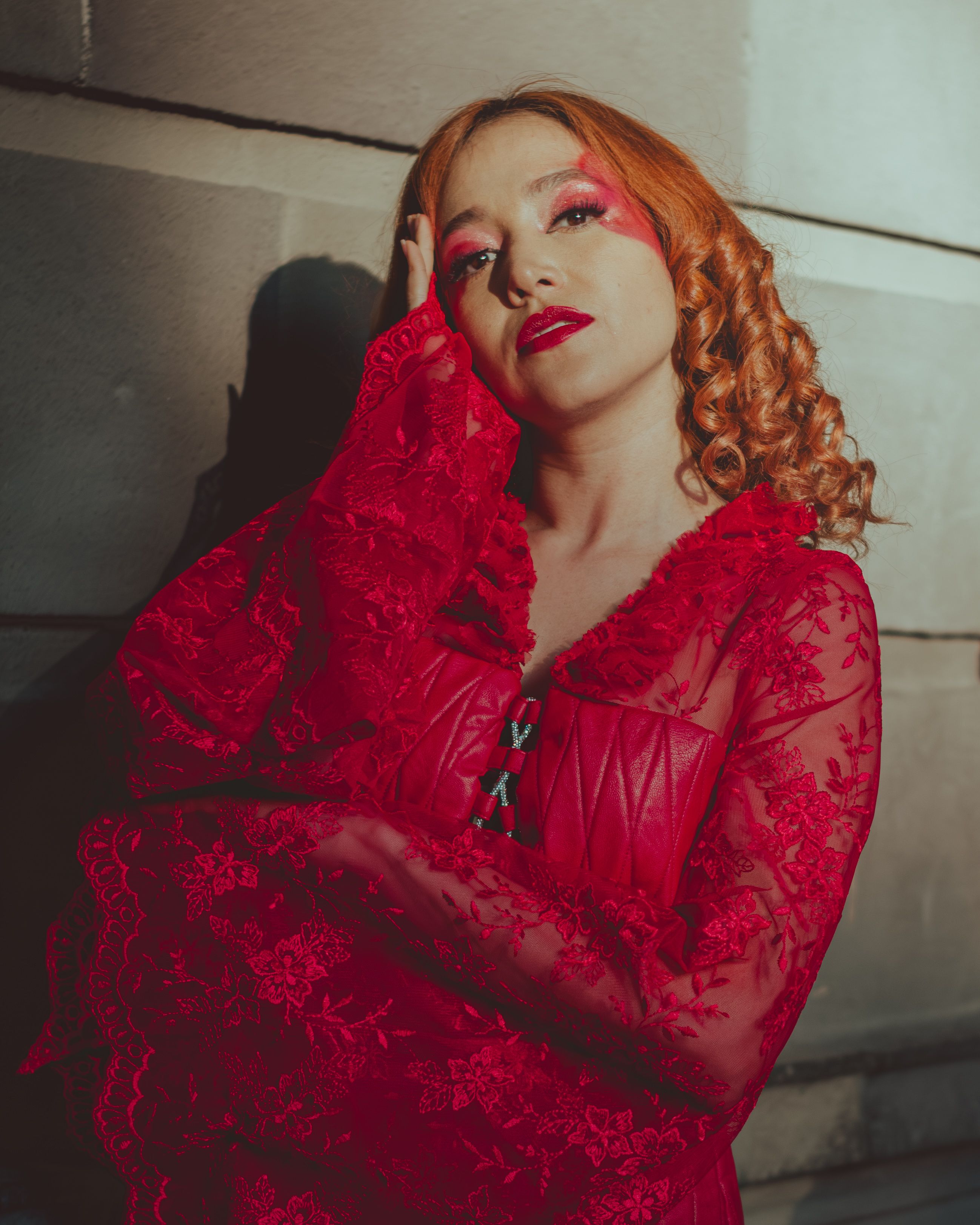 Elegant woman in vibrant red lace dress portrait · Free Stock Photo