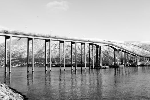 Black and white photo of Tromsø Bridge in winter.