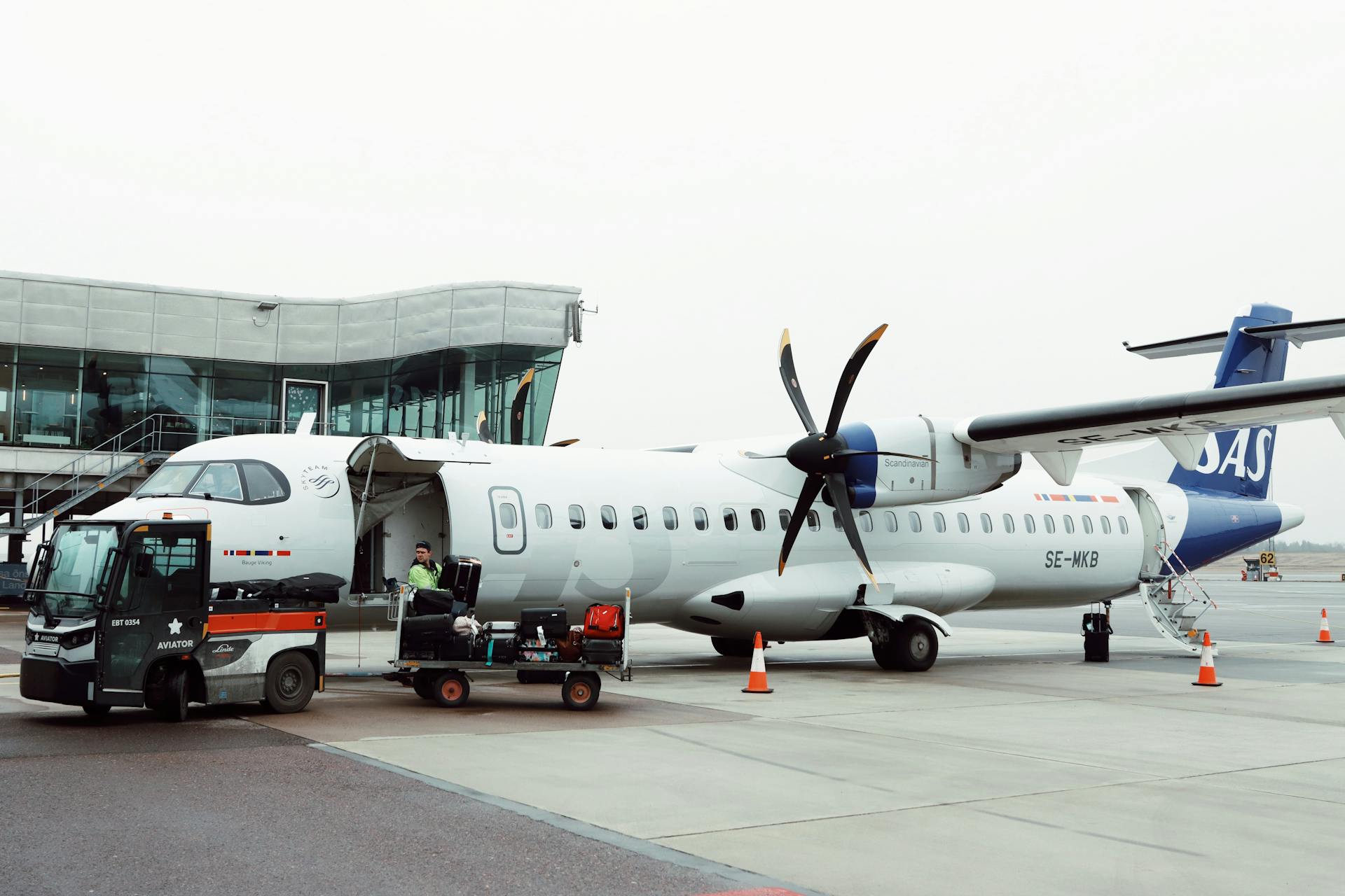 An SAS aircraft being loaded at Gothenburg airport in Sweden, showcasing airport operations.