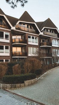Elegant residential building with geometric roofs and balconies, perfect for urban living.