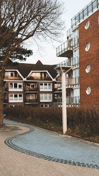 Contemporary apartment building with brick facade and unique round windows.