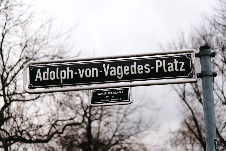 Street sign showcasing Adolph von Vagedes Platz, a historic location in Düsseldorf, Germany.