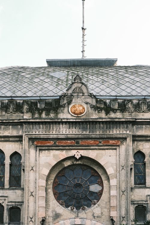 Free Detail of a historic European building facade with artistic windows. Stock Photo
