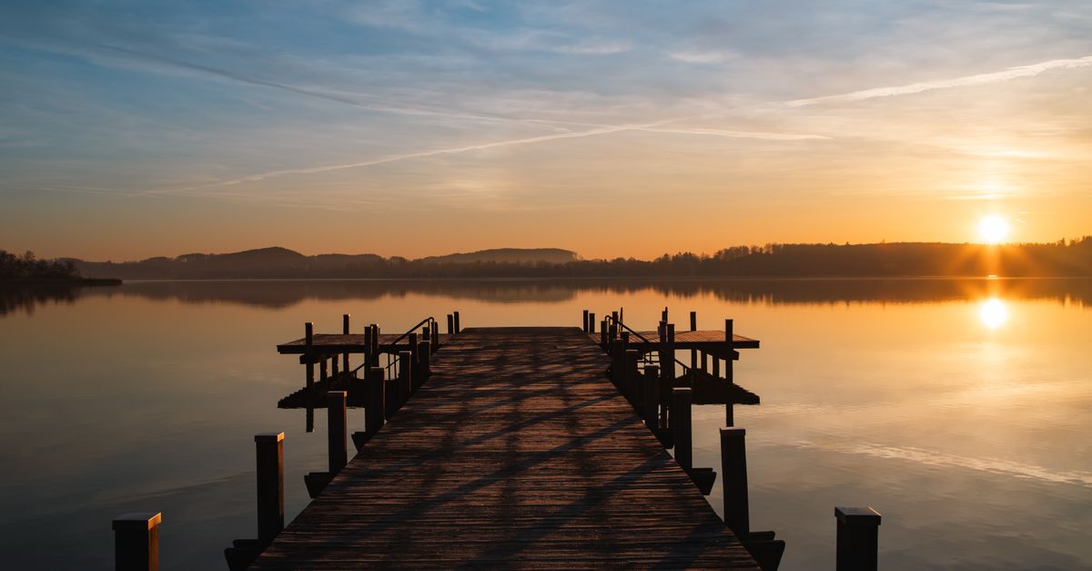 serene sunrise over calm water, symbolizing peace and neutrality