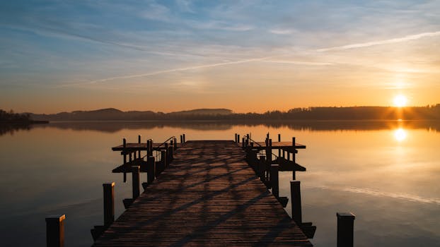 Tranquil sunrise at Wörthsee, Bavaria with a scenic pier view.