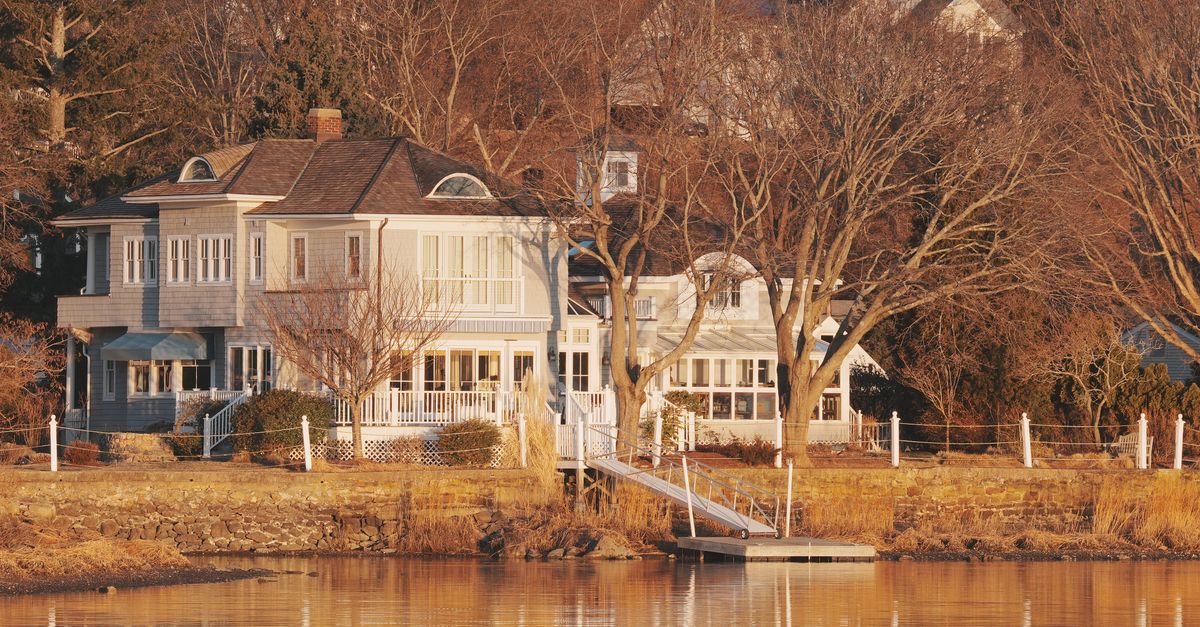 Beautiful waterfront home in Stamford, Connecticut captures serene morning light reflecting on the water.