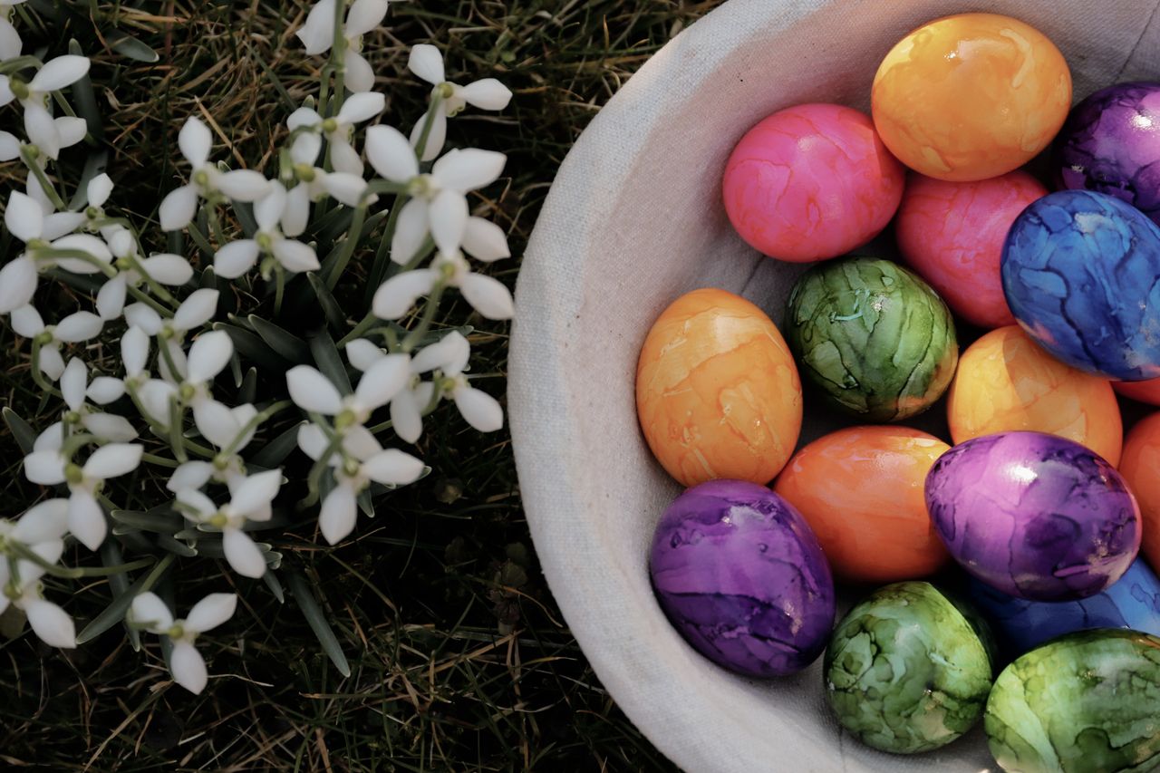 vibrant easter eggs in a basket with snowdrops celebrating spring outd