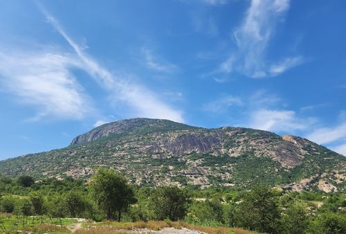 Free A stunning view of a rocky mountain under a bright blue sky, showcasing natural beauty. Stock Photo