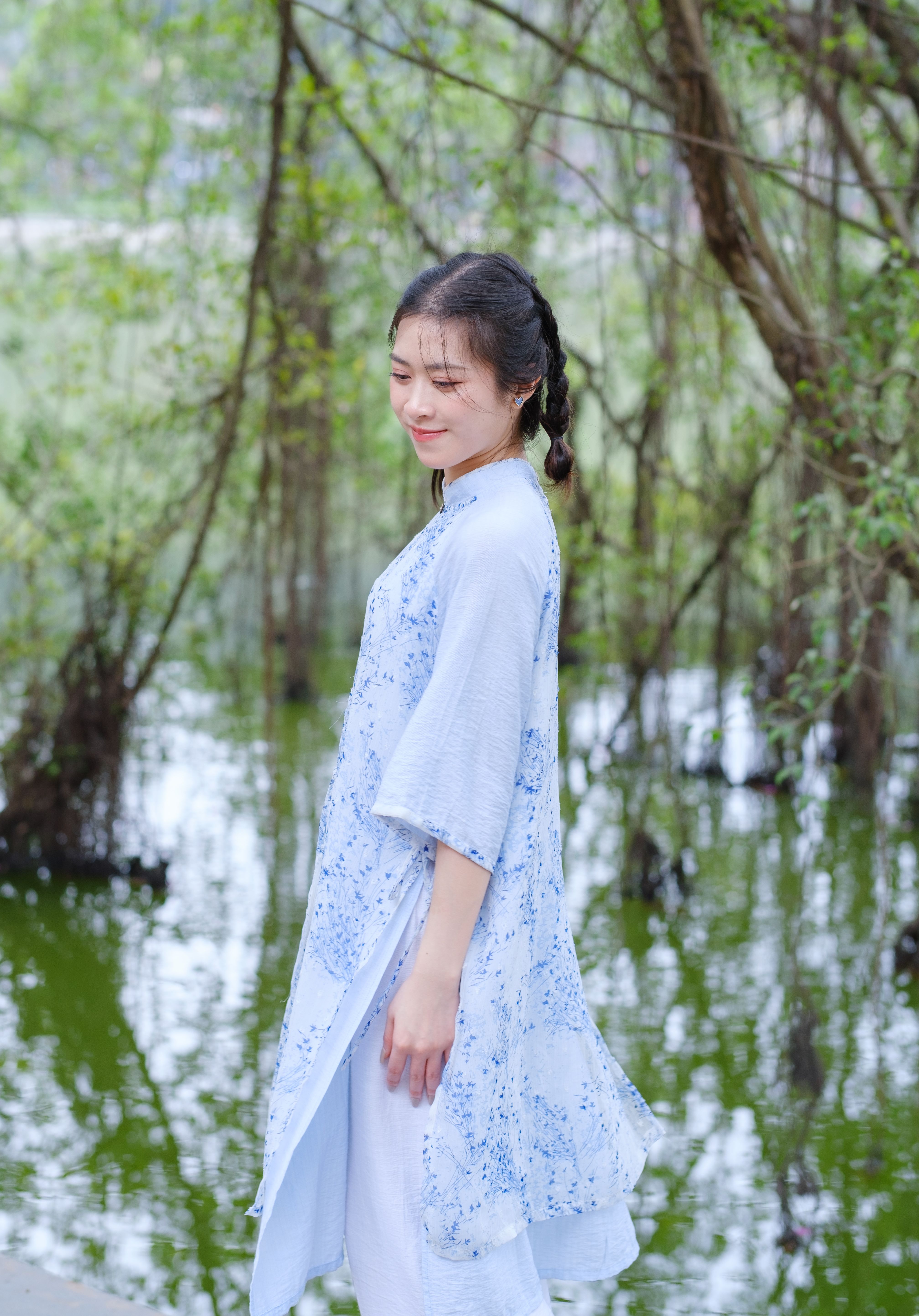 Woman in Traditional Dress by a Scenic River · Free Stock Photo