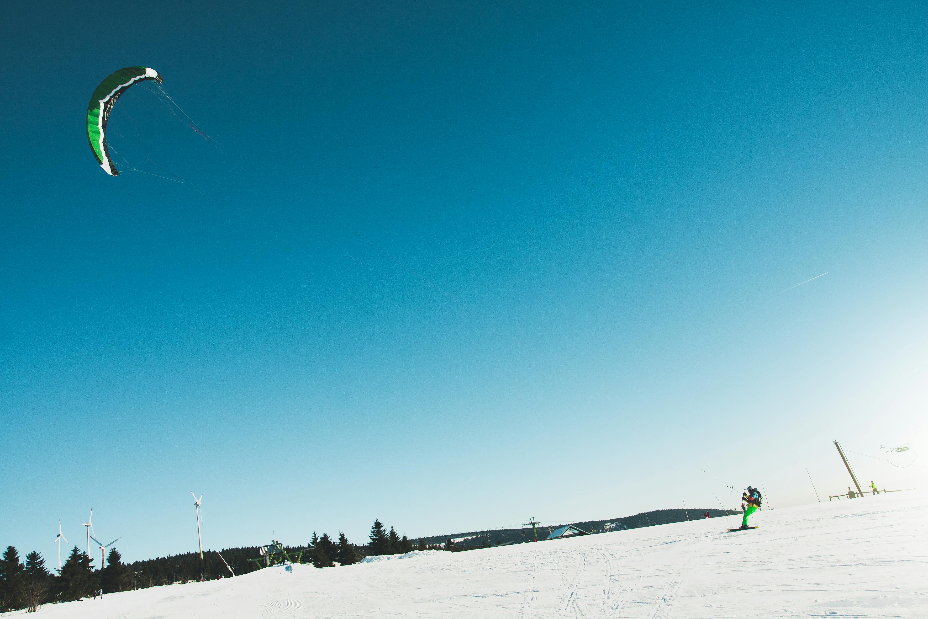 Snowkiter enjoying an exhilarating ride on a sunny winter day.