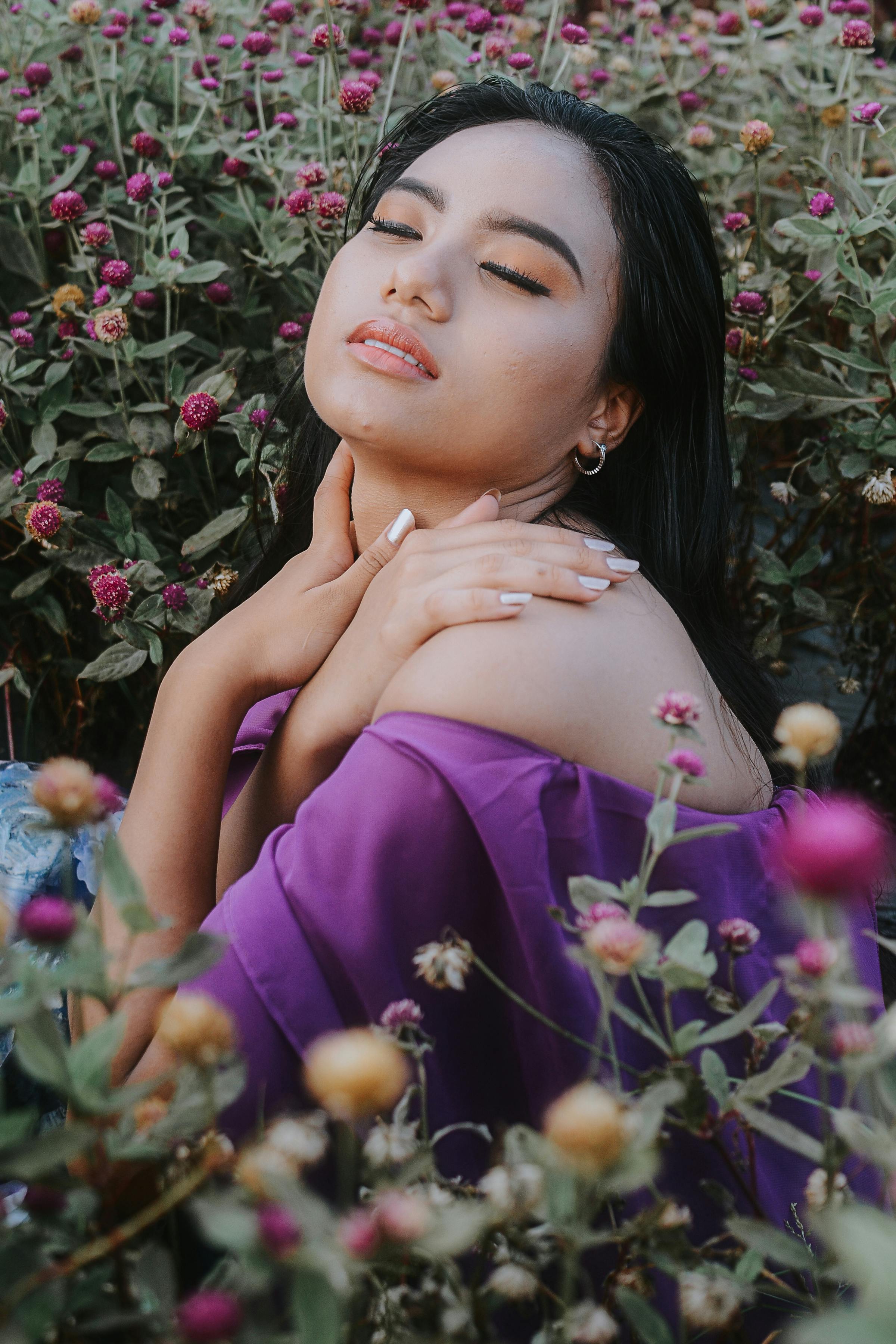 A serene portrait of a woman in a floral garden, capturing beauty and grace.