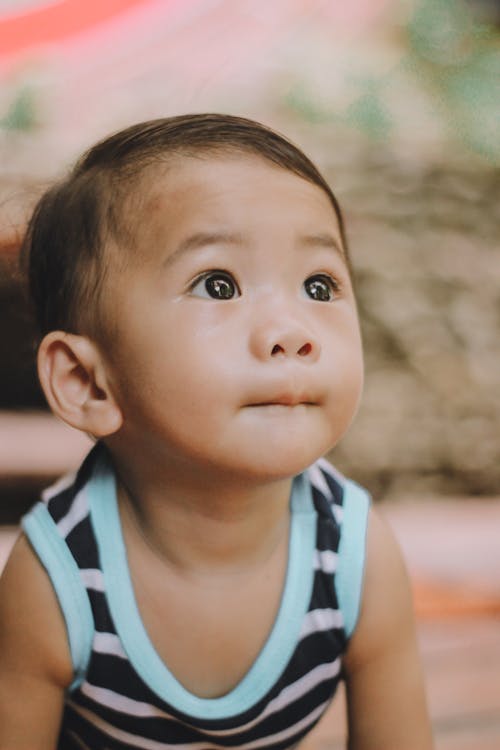 Photo of Toddler Wearing Black and White Striped Sleeveless Shirt