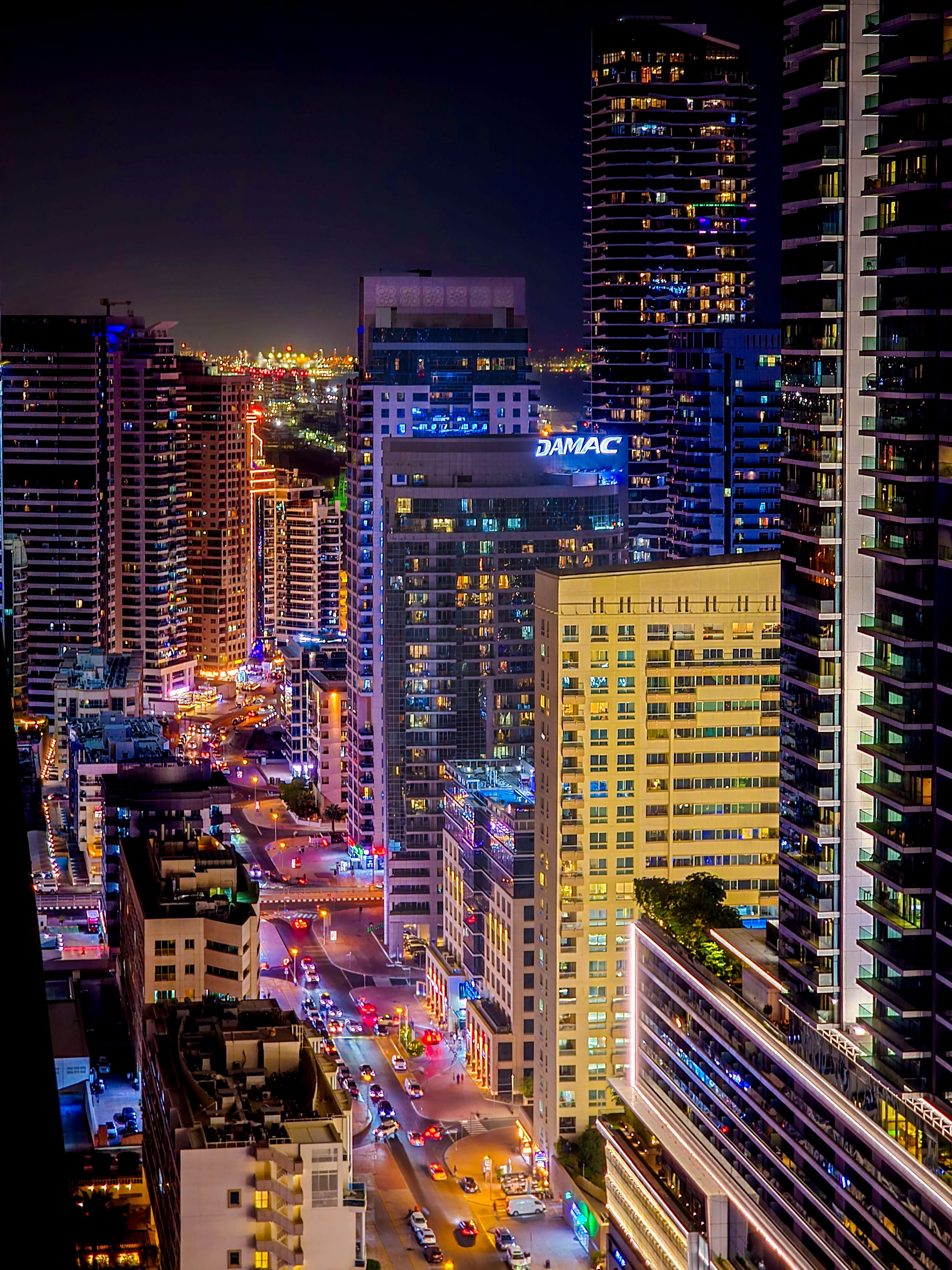 A stunning view of Dubai's dynamic cityscape at night, showcasing vibrant lights and skyscrapers.