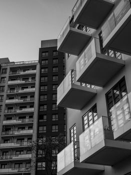 High-contrast black and white photo of modern apartment buildings.