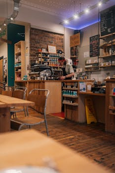 Inviting café interior in Fort William, Scotland. Warm and cozy atmosphere with a barista behind the counter.