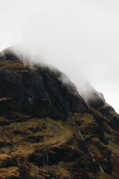 Free A dramatic mist-covered mountain in Fort William, Scotland, showcasing nature's beauty. Stock Photo