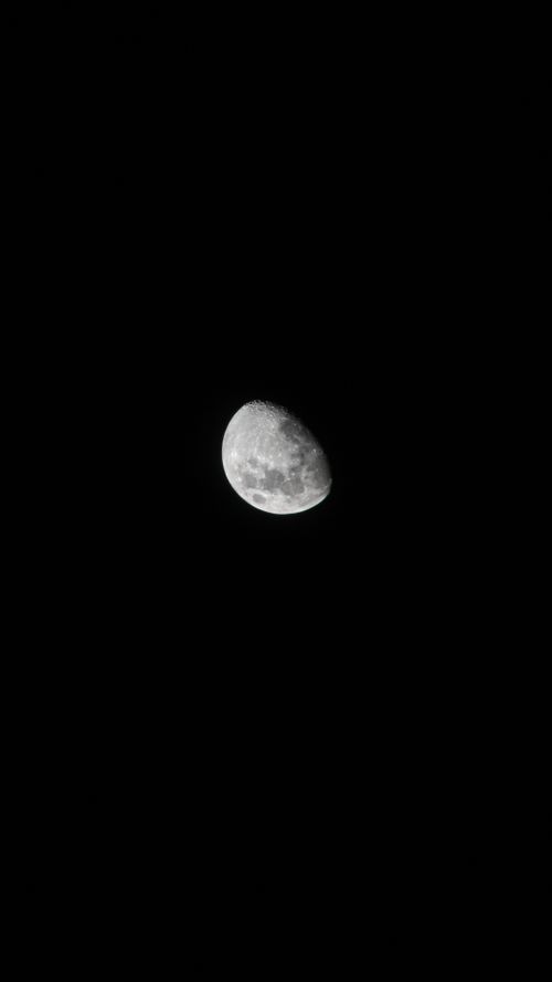 Free A detailed image of a crescent moon against a black night sky. Stock Photo