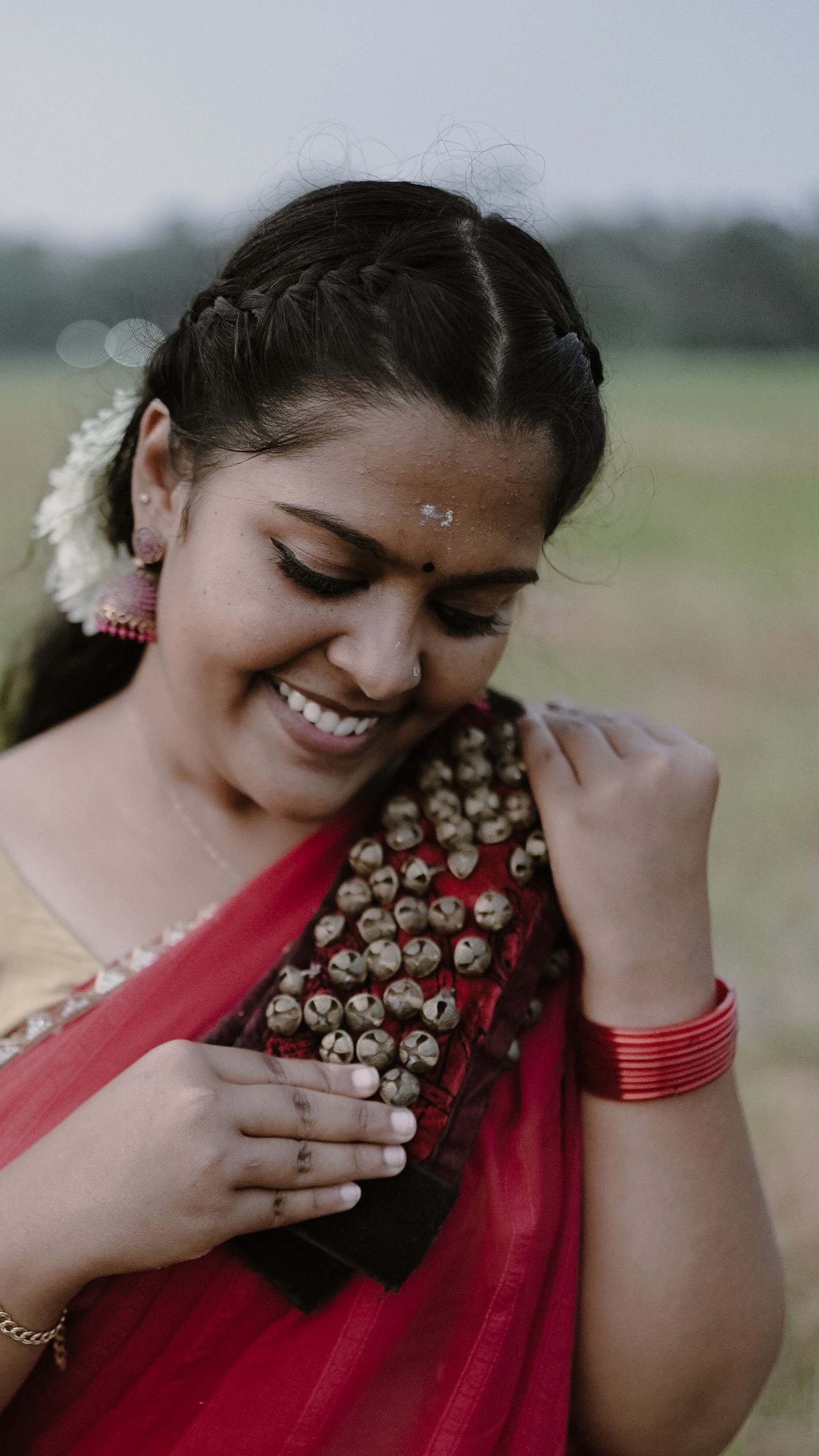 Woman in Traditional Attire Smiling Outdoors · Free Stock Photo