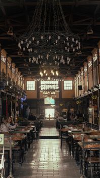 Warm, inviting restaurant interior with classic chandeliers and wooden decor.