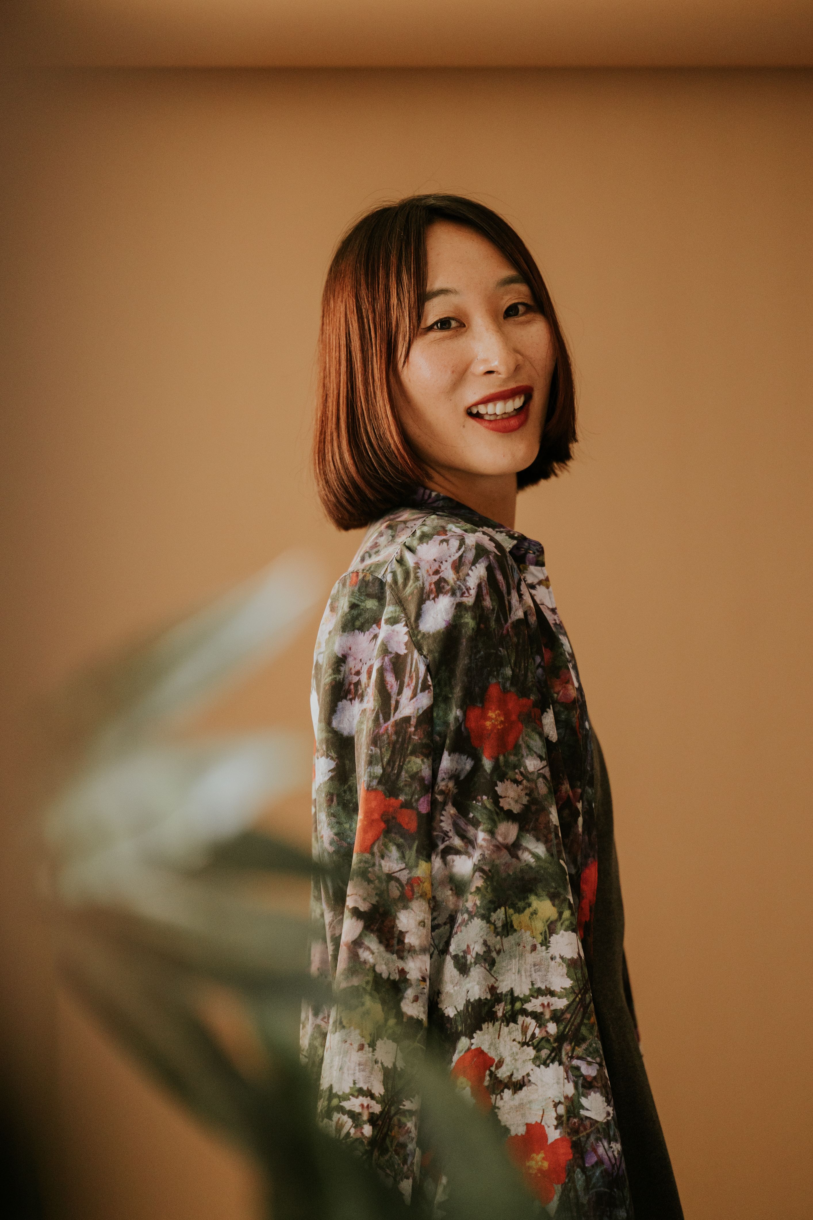 Portrait of a Smiling Woman in Floral Dress · Free Stock Photo