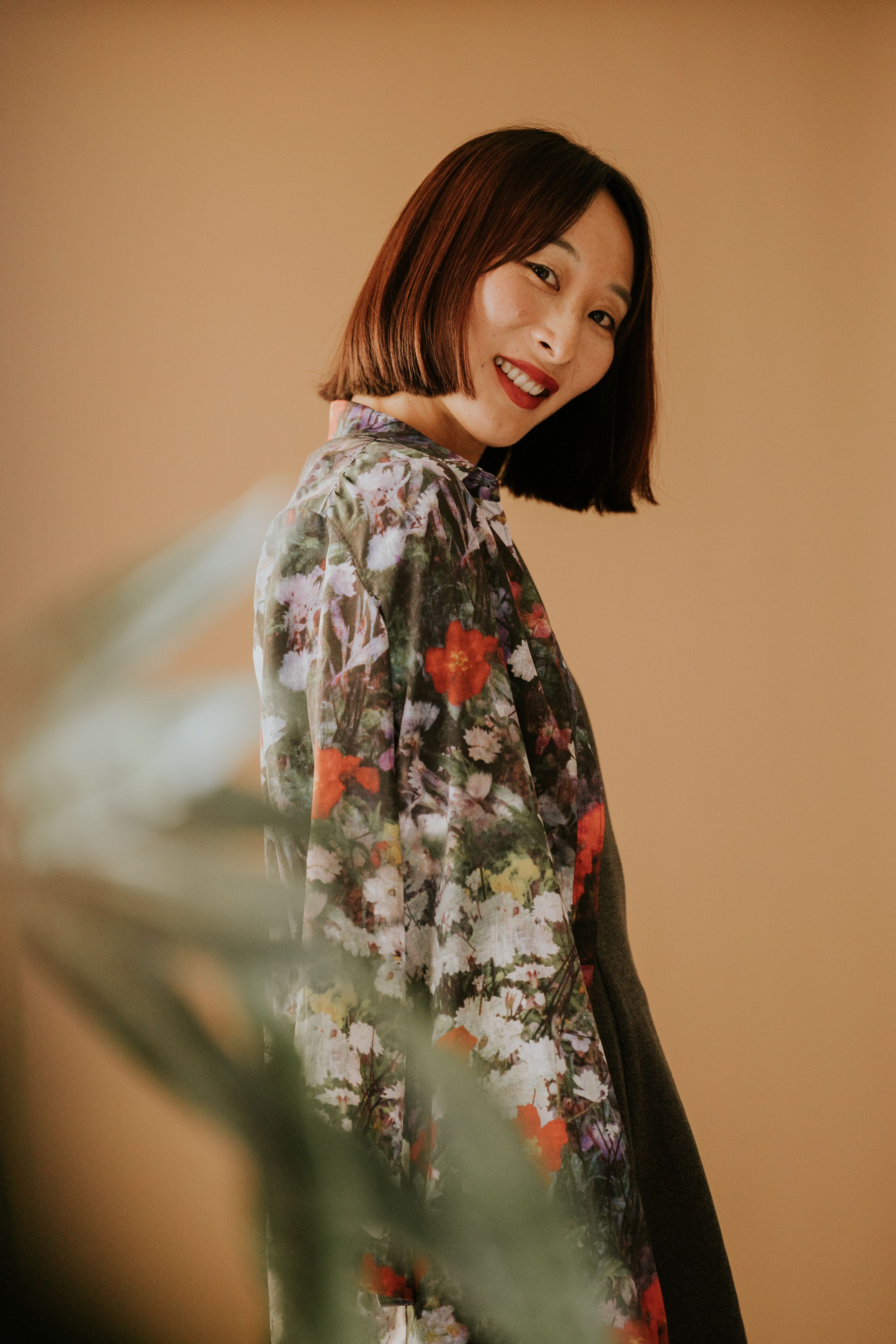 Stylish Woman in Floral Dress with Beige Background · Free Stock Photo