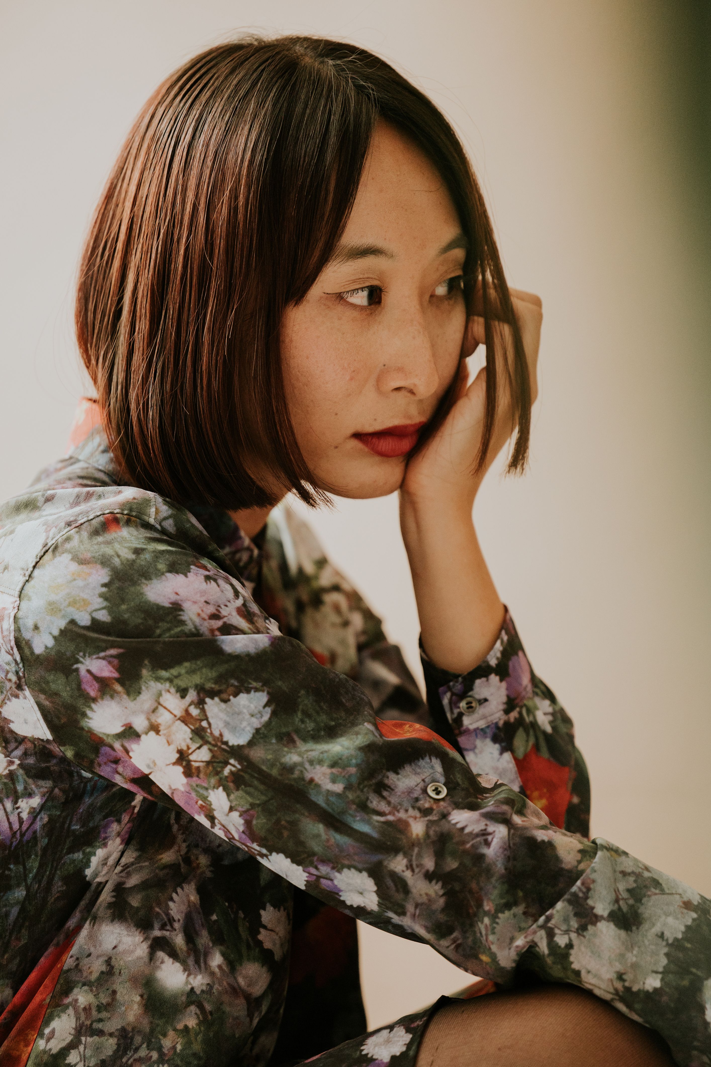 Thoughtful Woman in a Floral Dress Portrait · Free Stock Photo