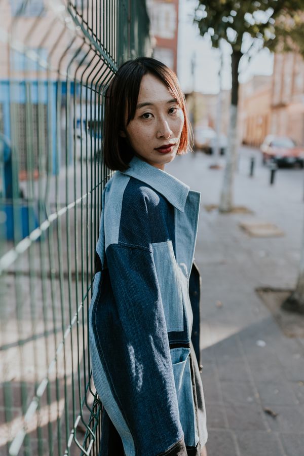 Woman wearing a utility jacket over a blouse in casual street style