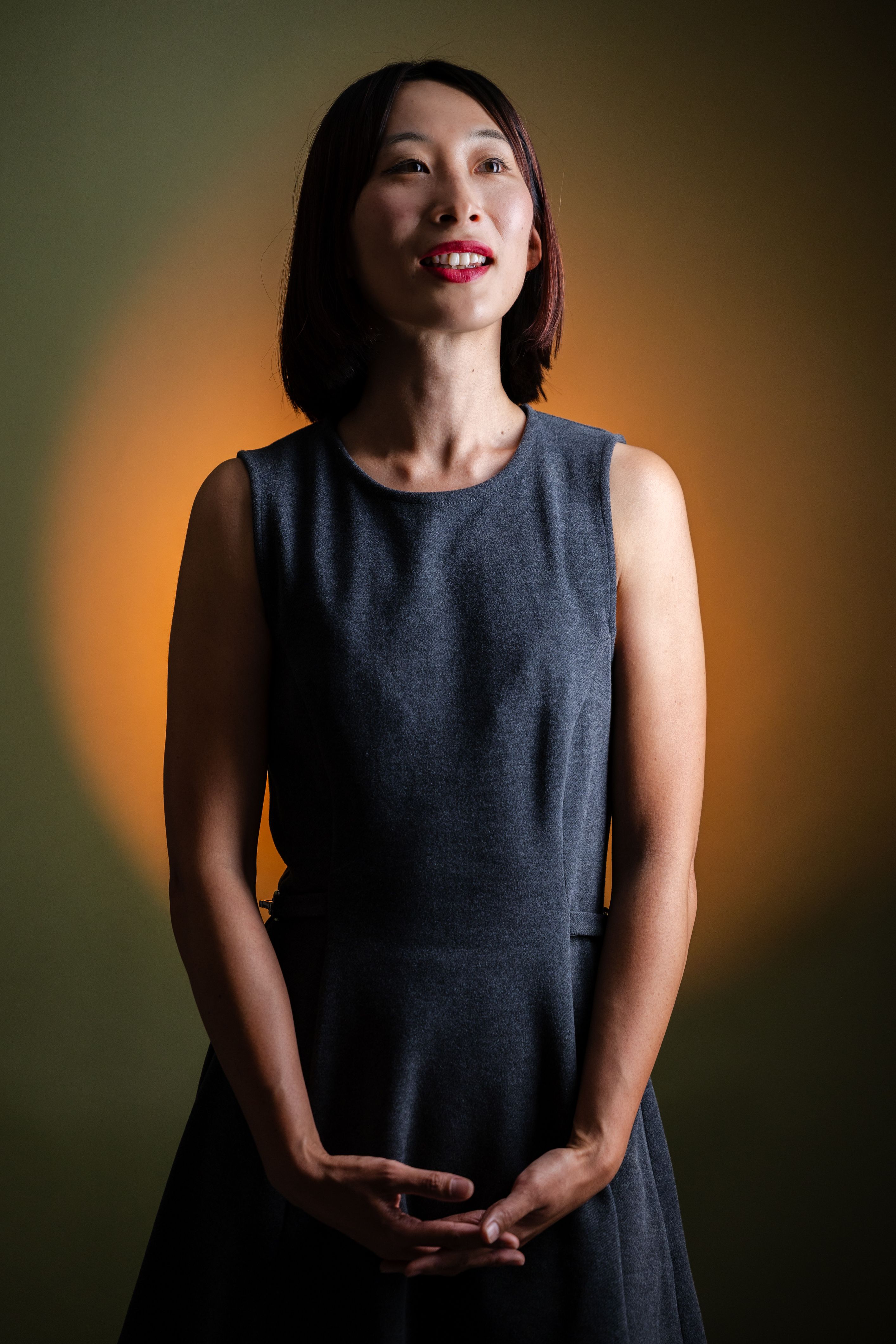 A serene portrait of an elegant woman with soft lighting and a warm backdrop.