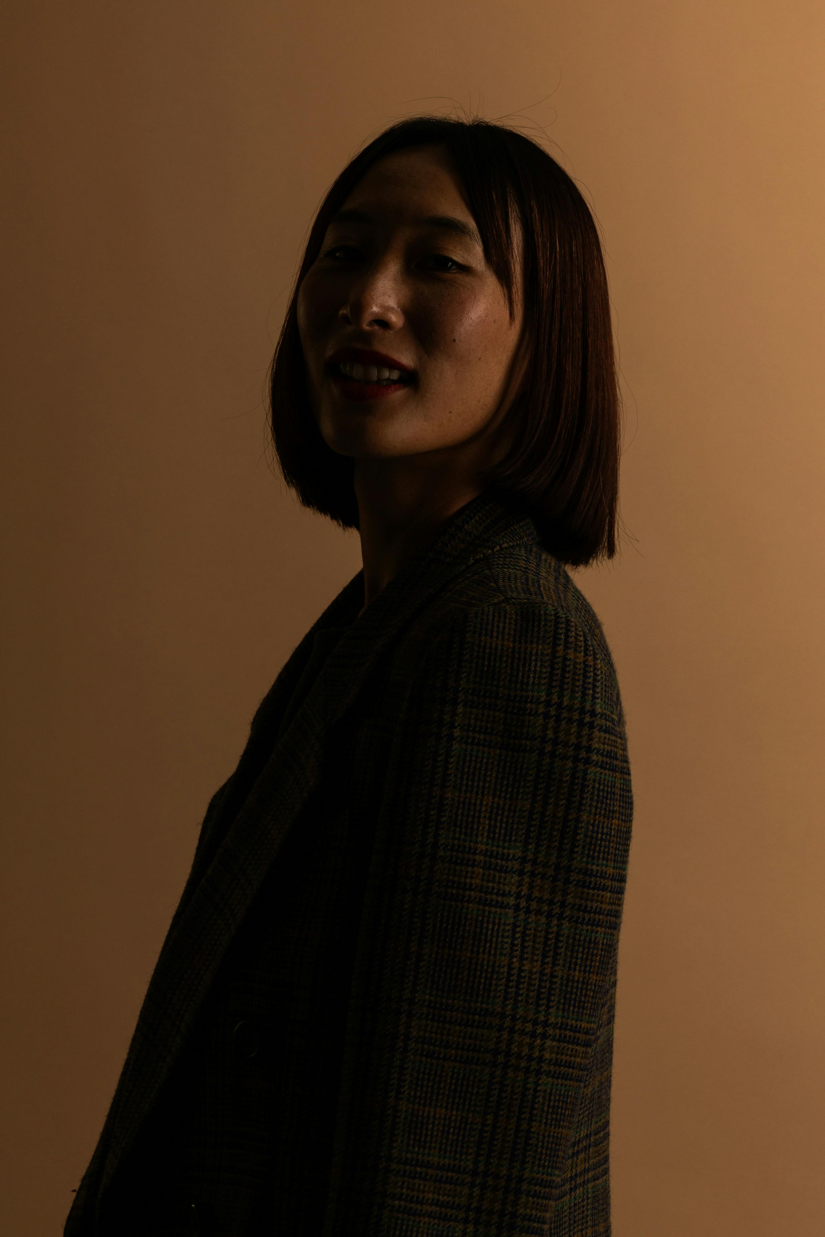 A silhouette portrait of a woman with a serene expression against a dark background.